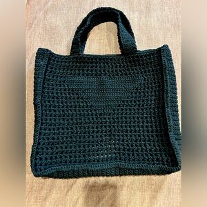 Hand crocheted. This black, heavy duty tote bag is 16” wide x 15” long x 4” -NEW
